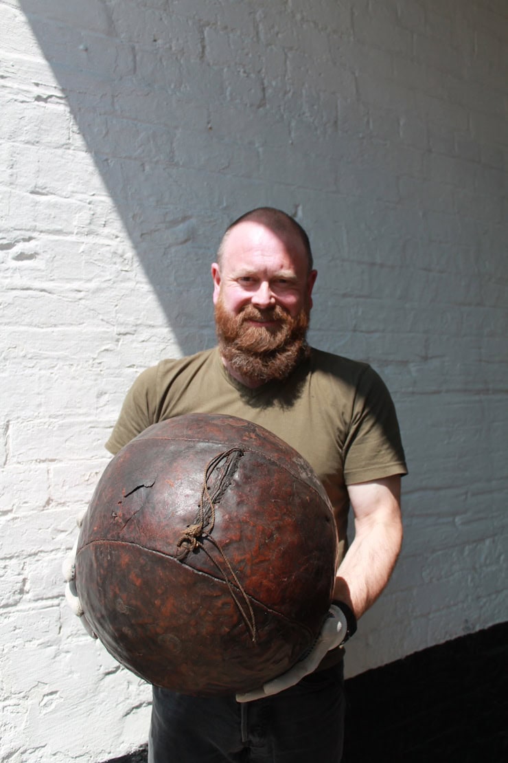 Spencer Bailey, curator collections manager at Derby Museums, with an original Derby Shrovetide Football. Copyright: I. Collis.