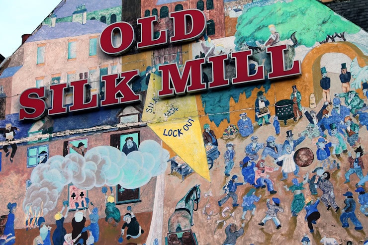 A mural on the Silk Mill public house commemorates the silk trades lockout of 1834. Derby Shrovetide football was still played despite union pressure. Copyright: I. Collis.